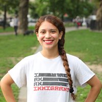 Picture of Student with a shirt that says I am an Immigrant.