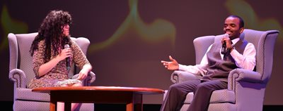 1 man speaker, seated. 1 woman speaker ,seated.