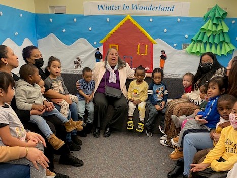 President Daisy Cocco De Filippis reading to children
